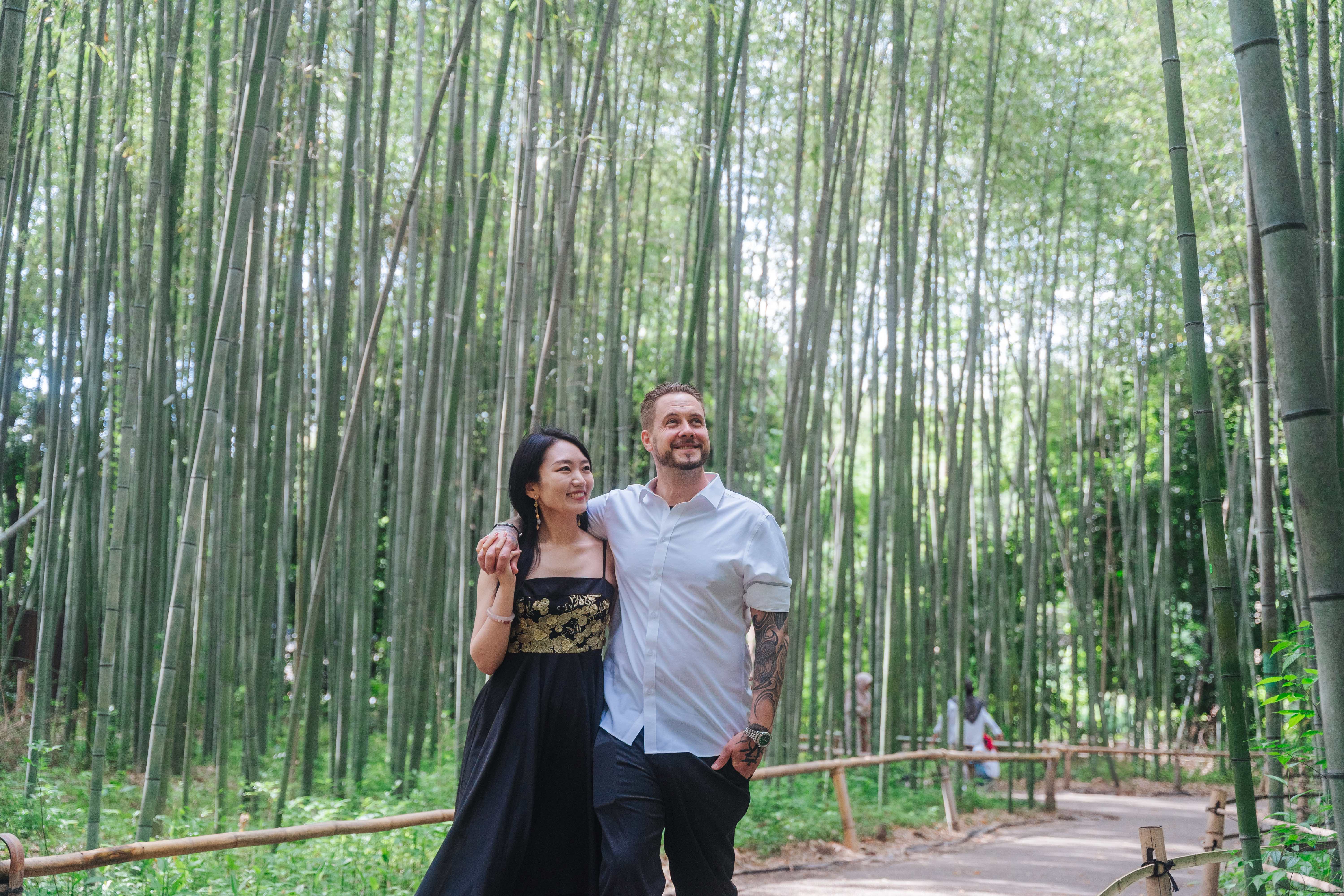 Couple embracing in magical Arashiyama bamboo forest in Kyoto