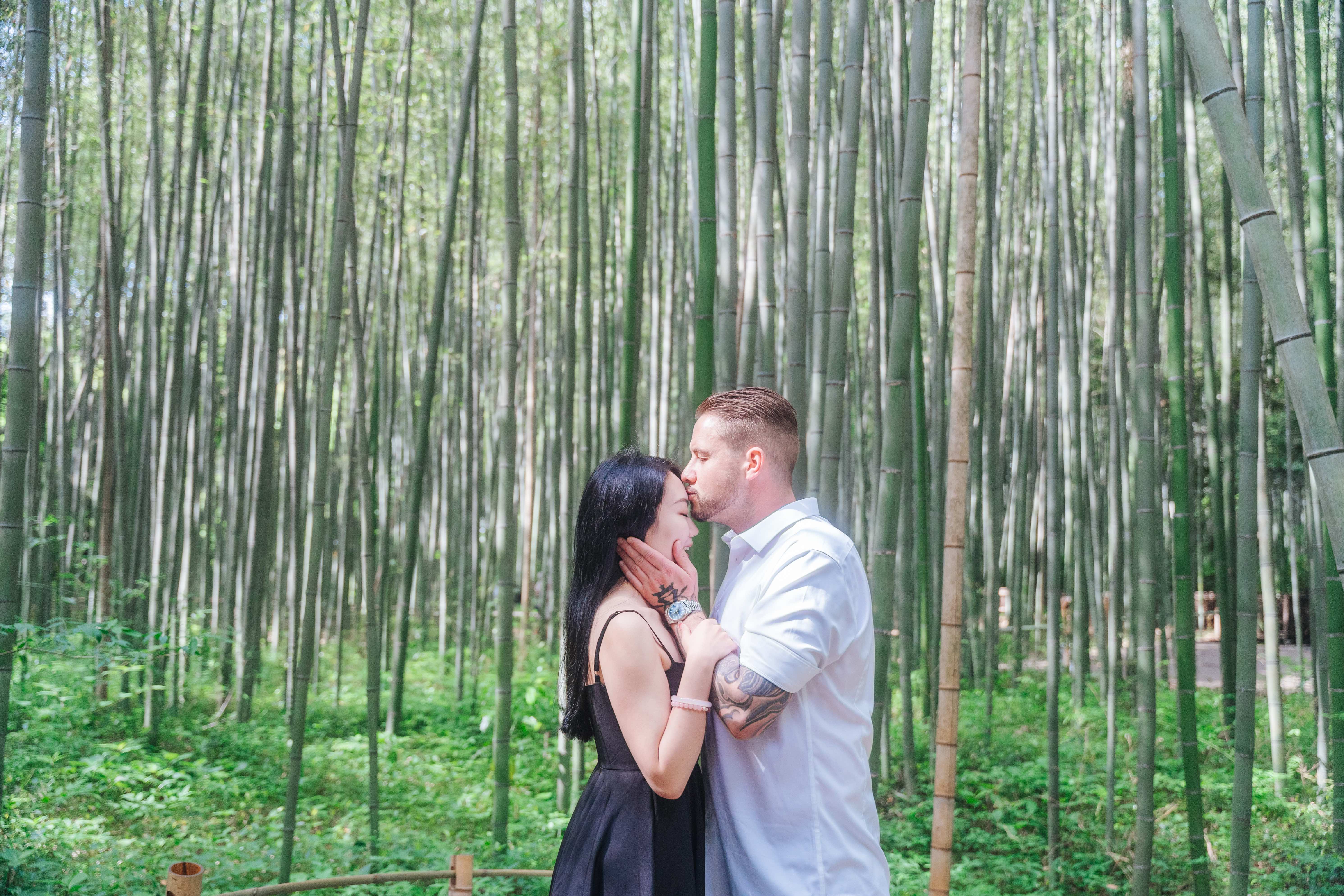 Tender kiss moment in enchanting bamboo forest - romantic photography