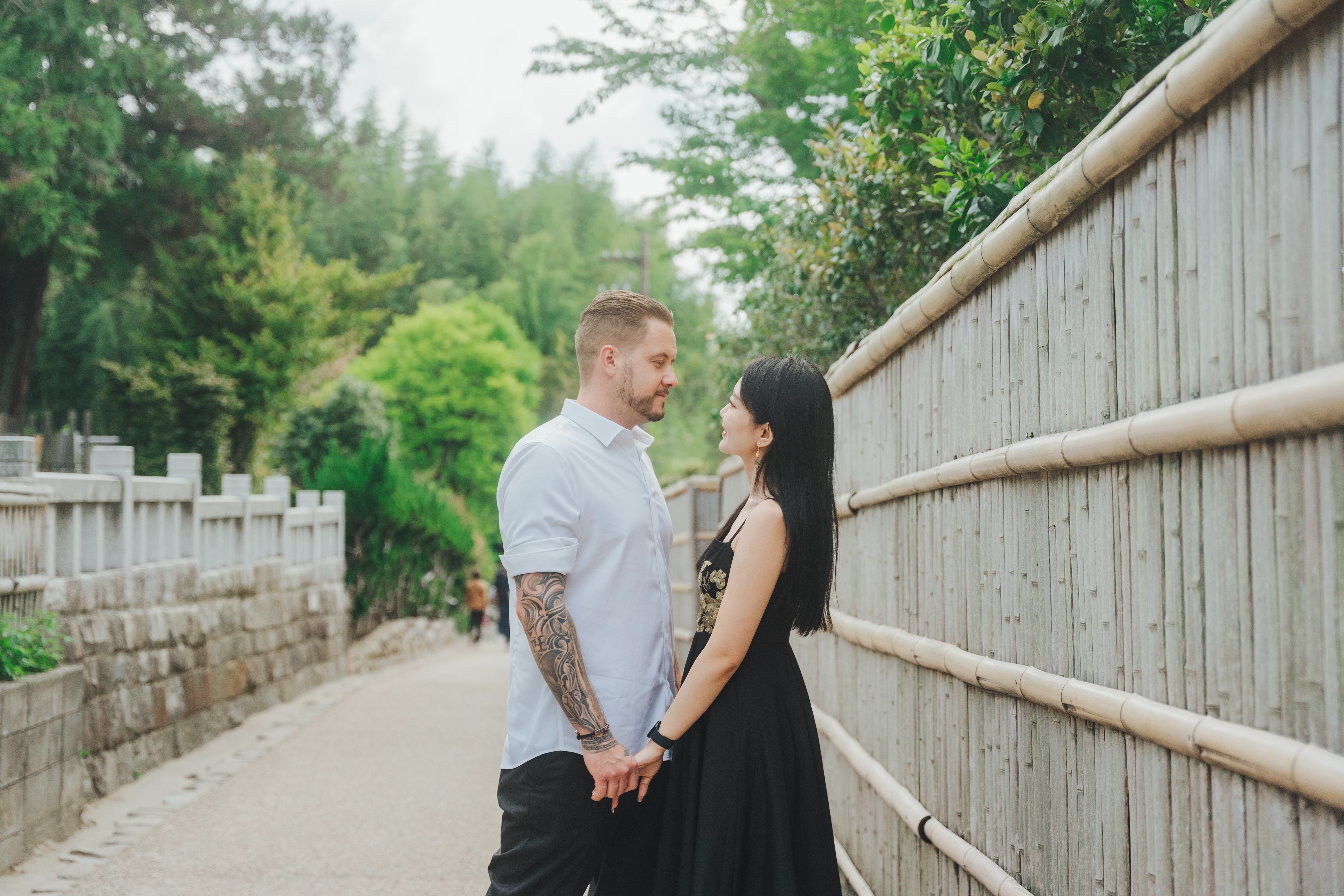 Intimate couple moment on traditional Japanese bamboo pathway