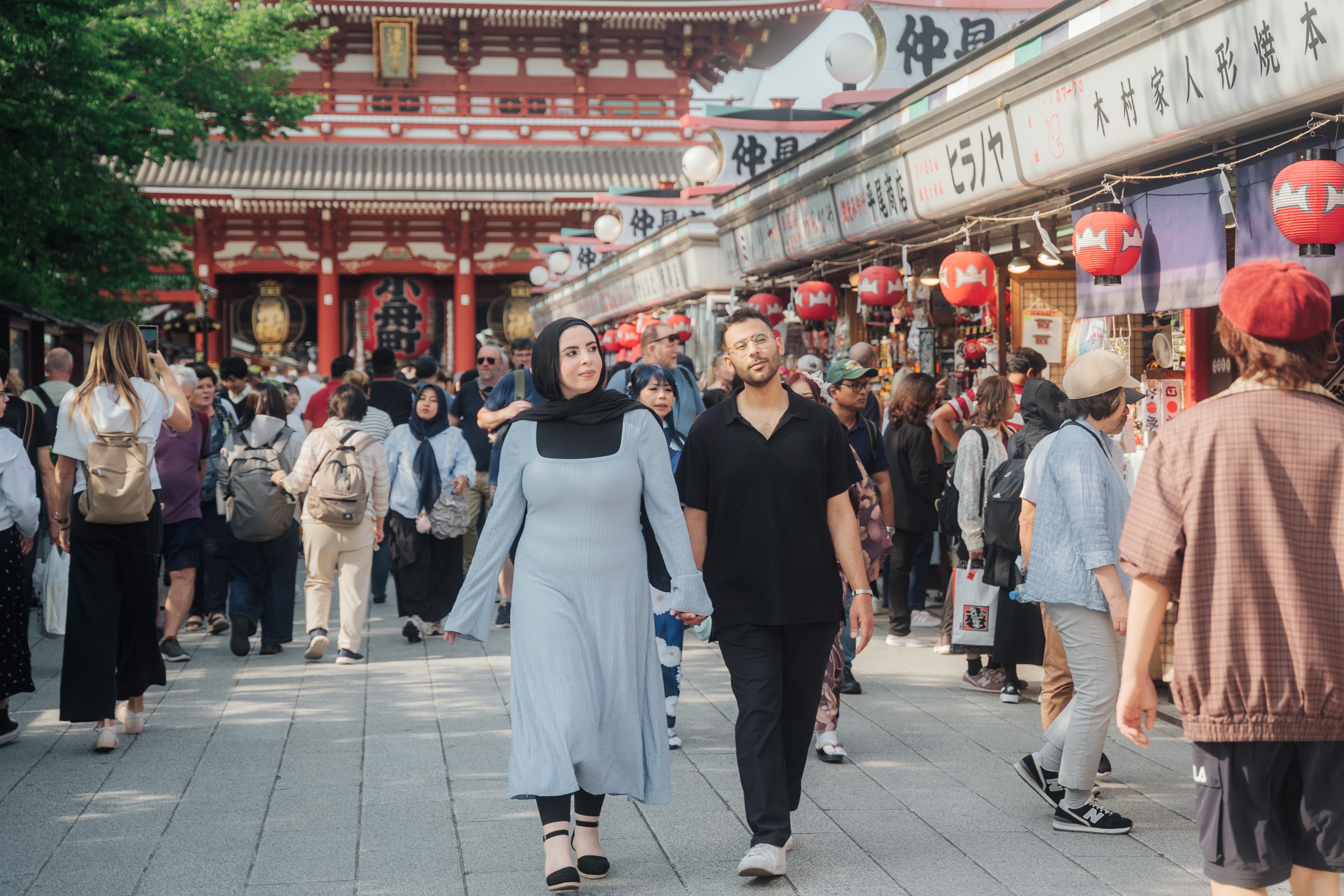 Couple walking through Sensoji Temple Nakamise shopping street
