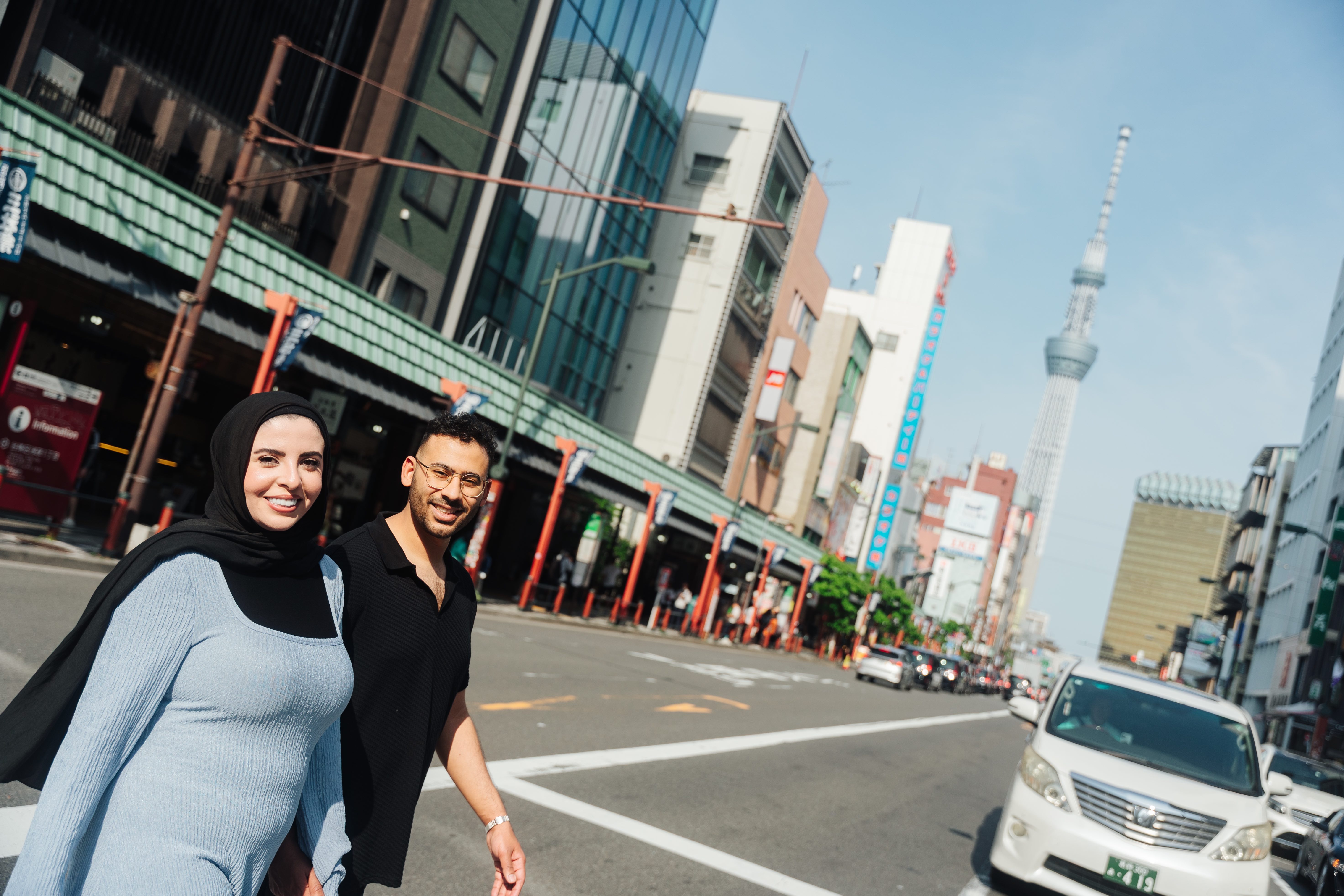 Couple on Tokyo street with Skytree in background - urban romance photography
