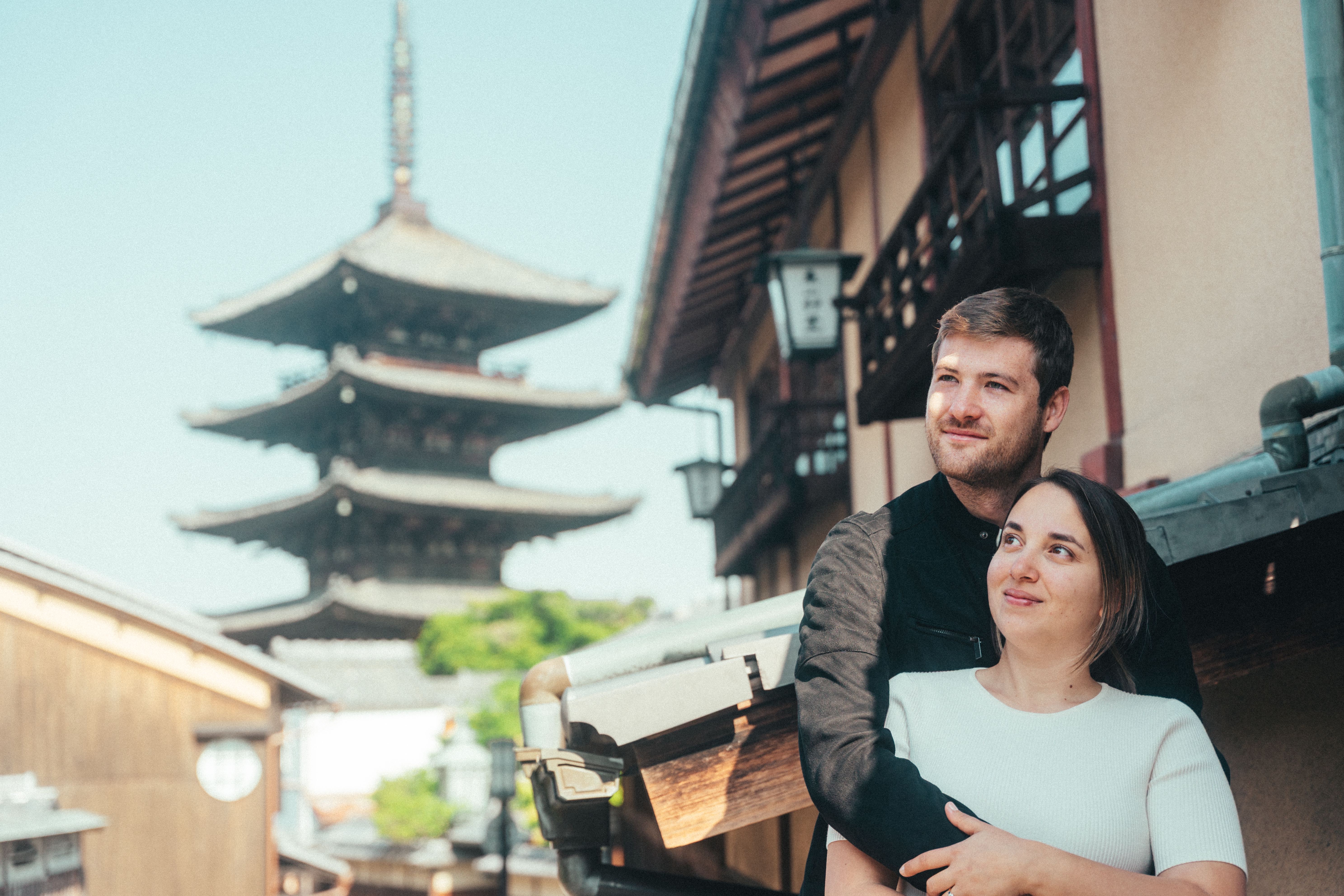 Romantic couple portrait at traditional Japanese temple with pagoda